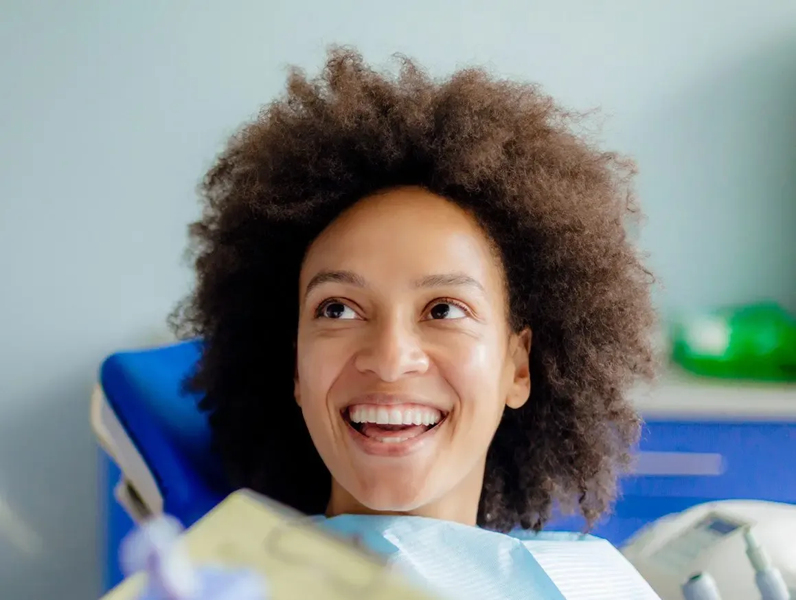 Dentistry New York NY Positive Dental Experience Curly Haired Woman